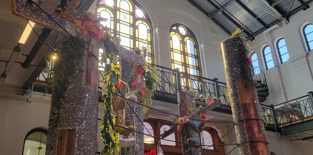 Glittering poles with flowers and greeneries and shoes as witnesses to lives lost.