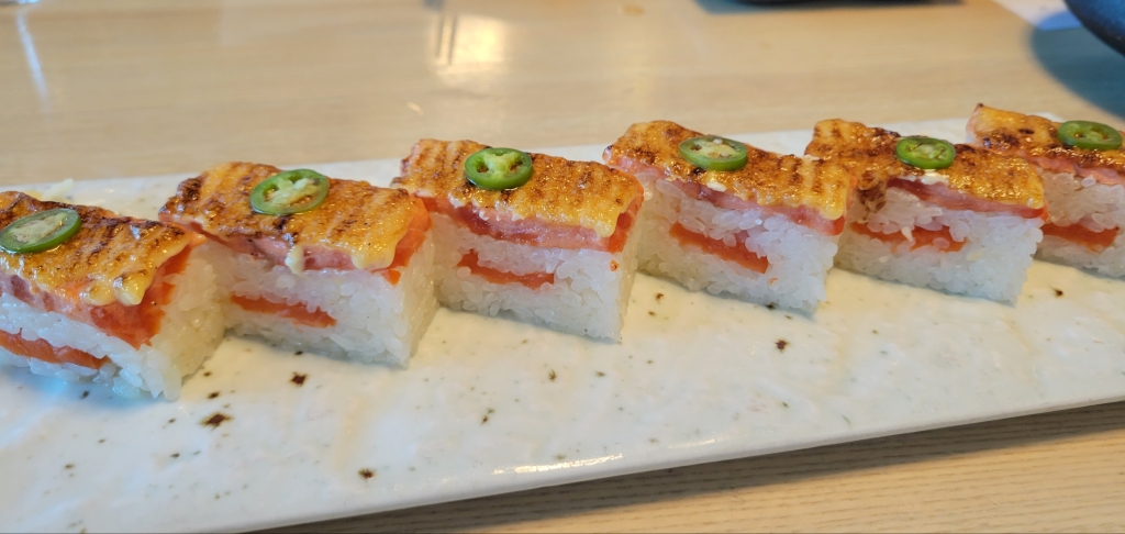 A row of high end rectangular avacado sushi from a restaurant in Vancouver, BC.
