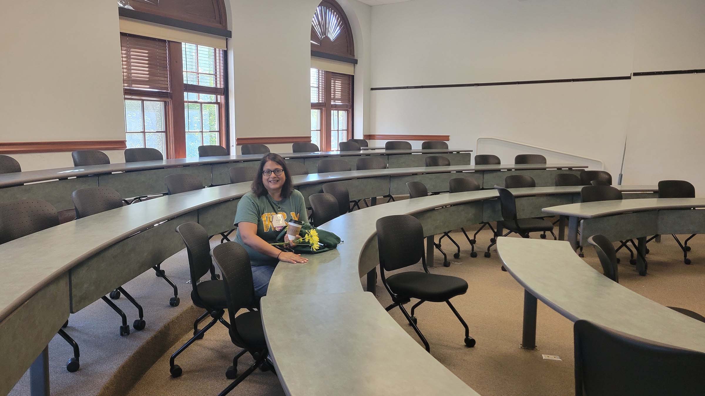 Priya sitting in a classroom in Blair at William & Mary.
